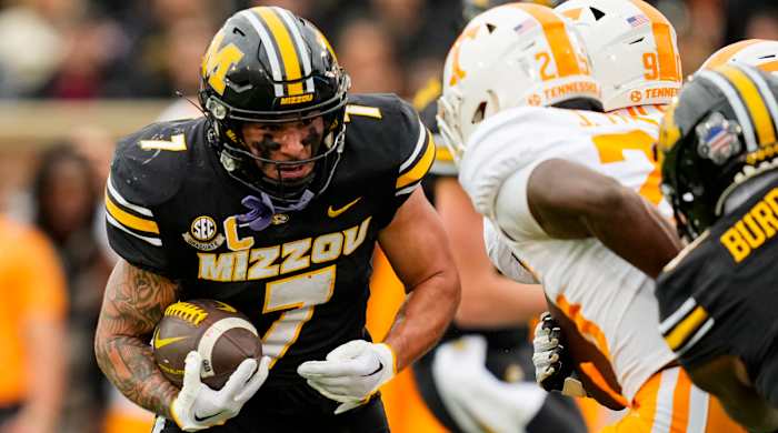Missouri running back Cody Schrader braces for impact against a Tennessee defender